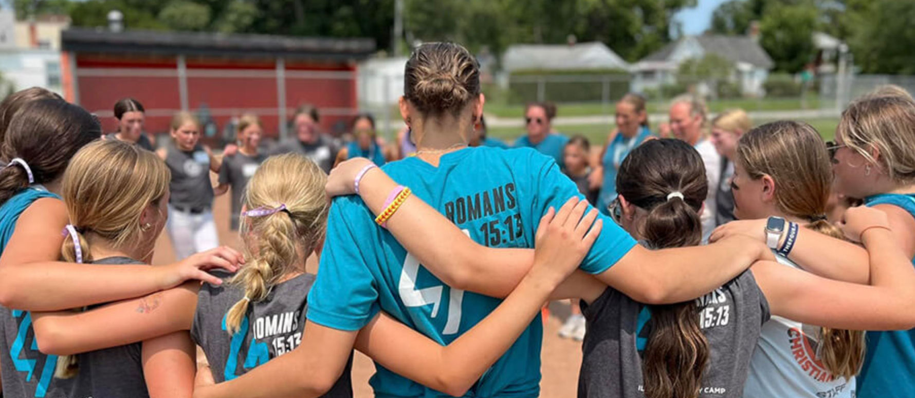 Athletes praying together in a huddle